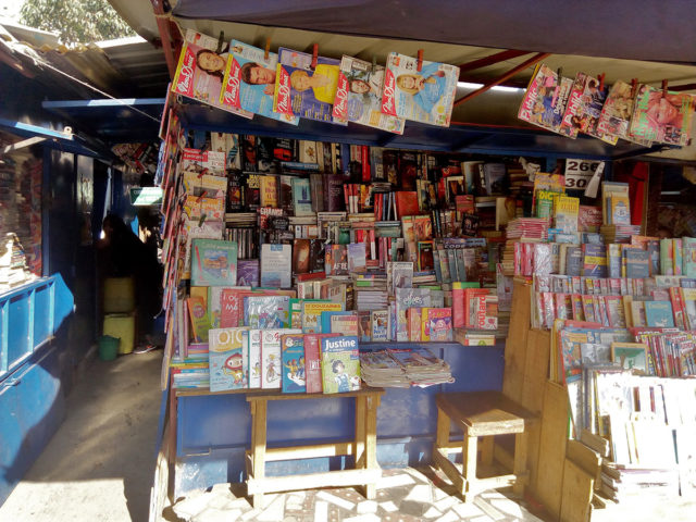 Un stand de livres d'occasion situé en premier plan à Ambohijatovo